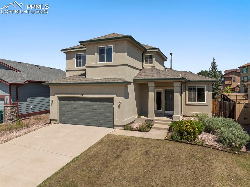 Image 39 of 49: Prairie-style home with stucco siding, a shingled roof, an attached garage,