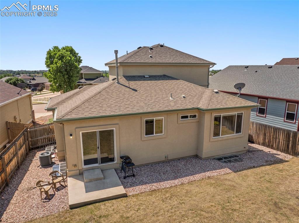 Image 42 of 49: Rear view of property with a shingled roof, a fenced backyard, a patio area