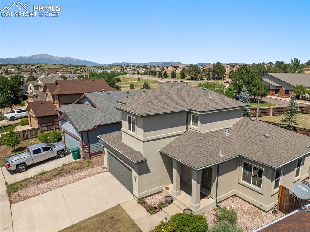 Image 45 of 49: Aerial perspective of suburban area featuring a mountainous background