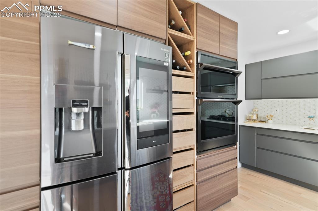 Image 14 of 47: Kitchen with modern cabinets, appliances with stainless steel finishes, ope