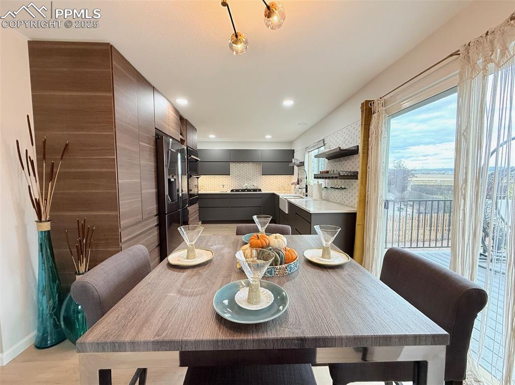 Image 19 of 47: Dining room featuring light wood finished floors and recessed lighting