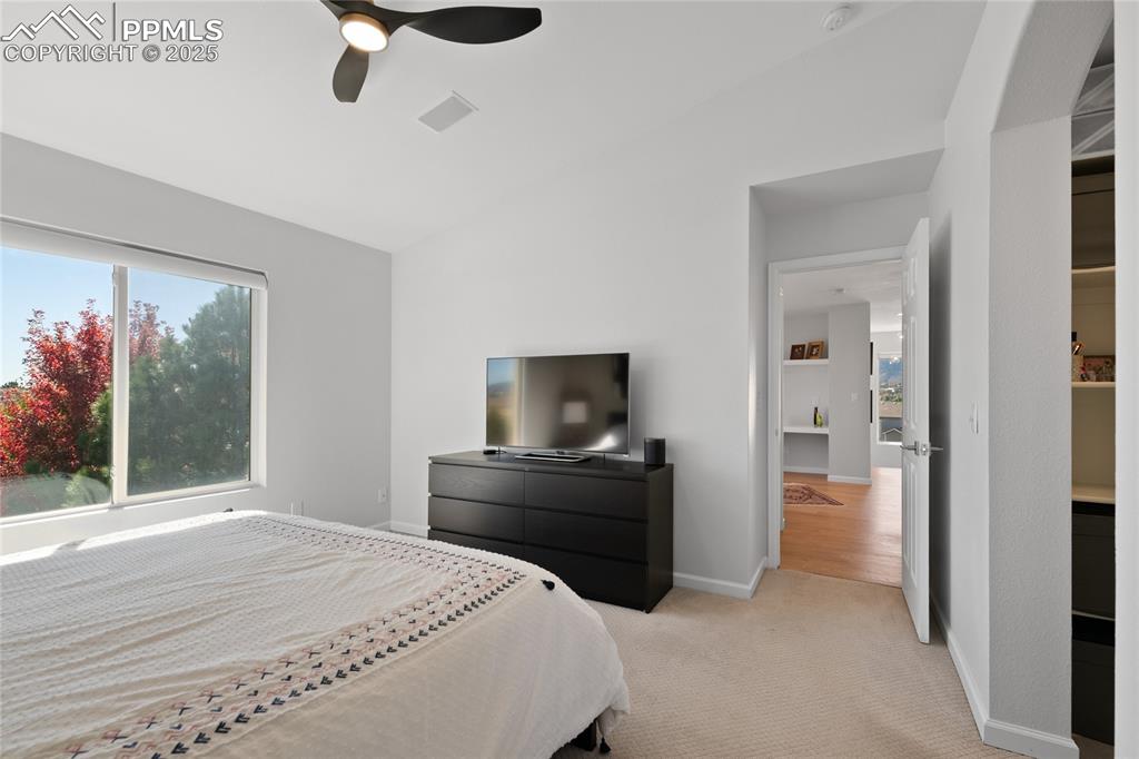 Image 30 of 47: Bedroom with carpet, a ceiling fan, and vaulted ceiling