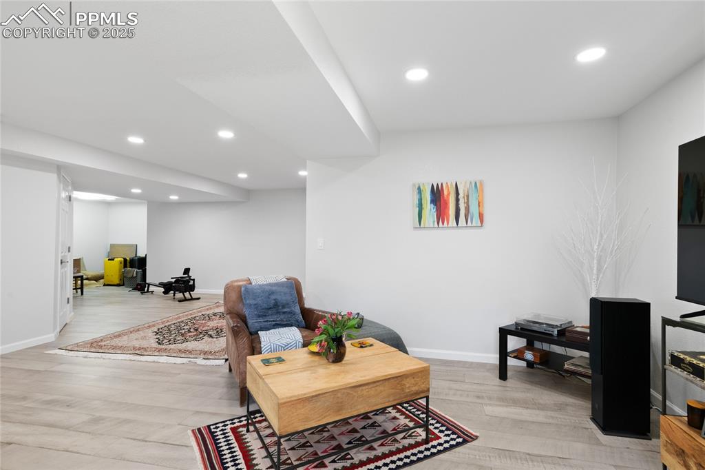 Image 41 of 47: Living room featuring recessed lighting and light wood-style flooring