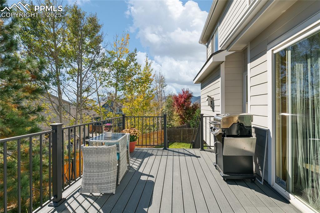 Image 43 of 47: Wooden deck featuring area for grilling and outdoor dining area