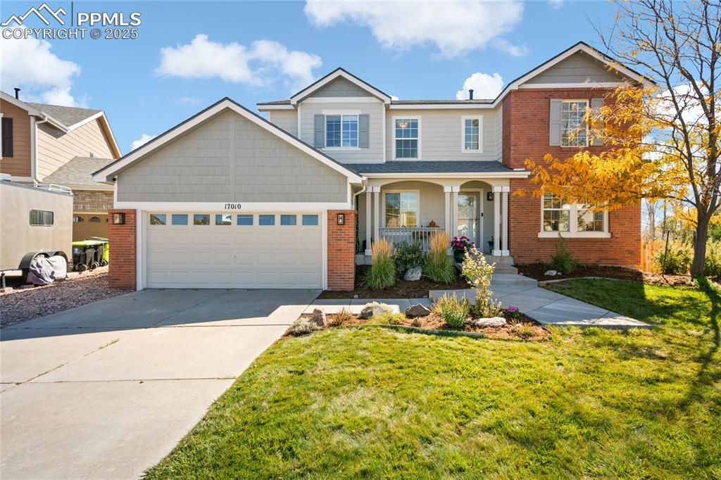Image 47 of 47: Traditional-style house featuring covered porch, concrete driveway, a front