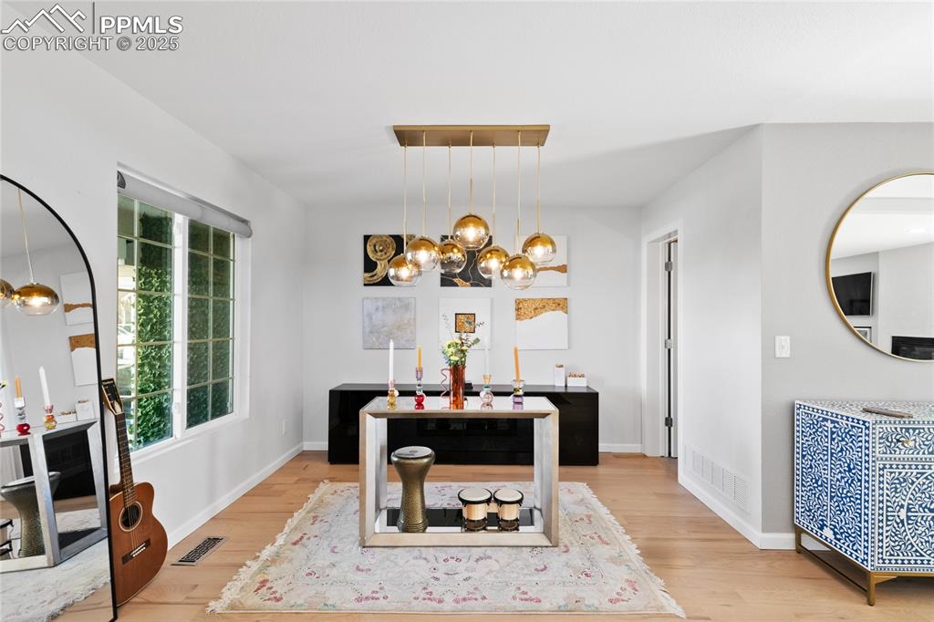 Image 5 of 47: Dining room featuring a chandelier and light wood-style flooring
