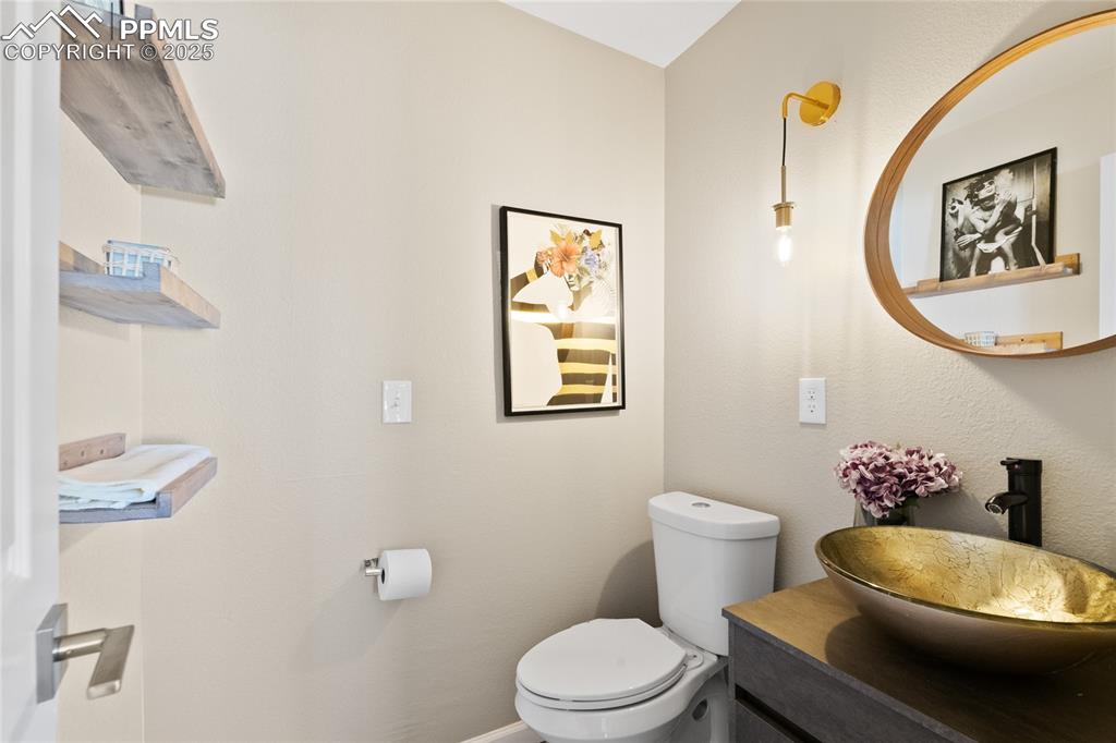 Image 6 of 47: Half bathroom with toilet and vanity