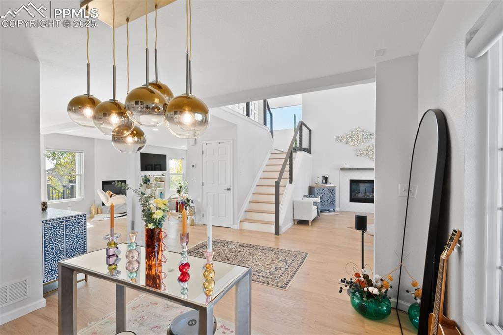 Image 8 of 47: Entrance foyer with healthy amount of natural light, a glass covered firepl