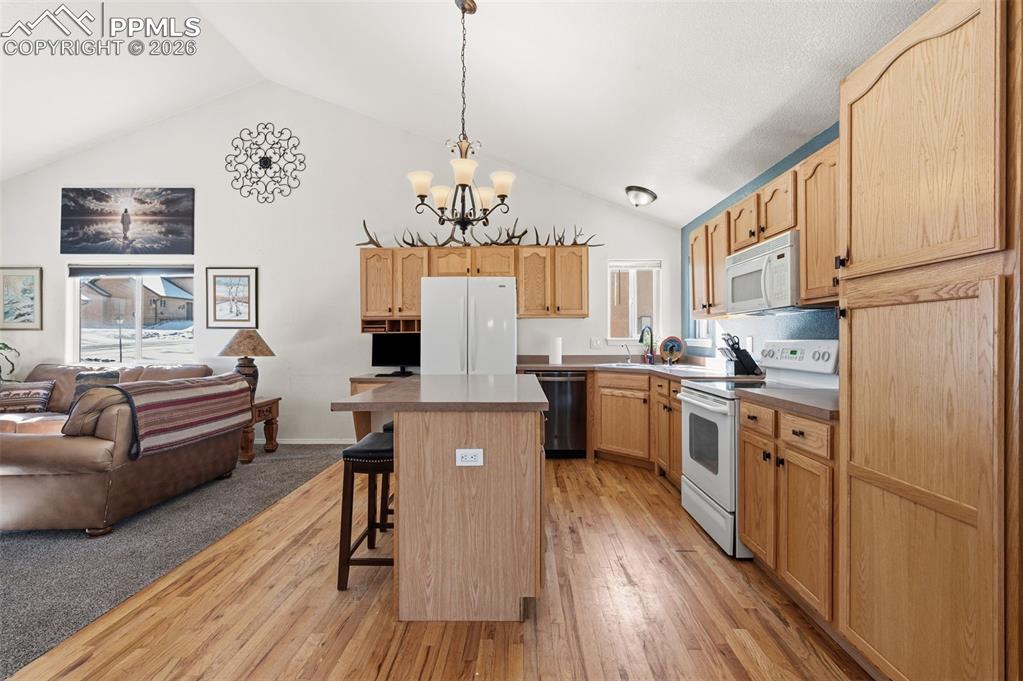 Image 12 of 36: Main level kitchen with open concept to living room