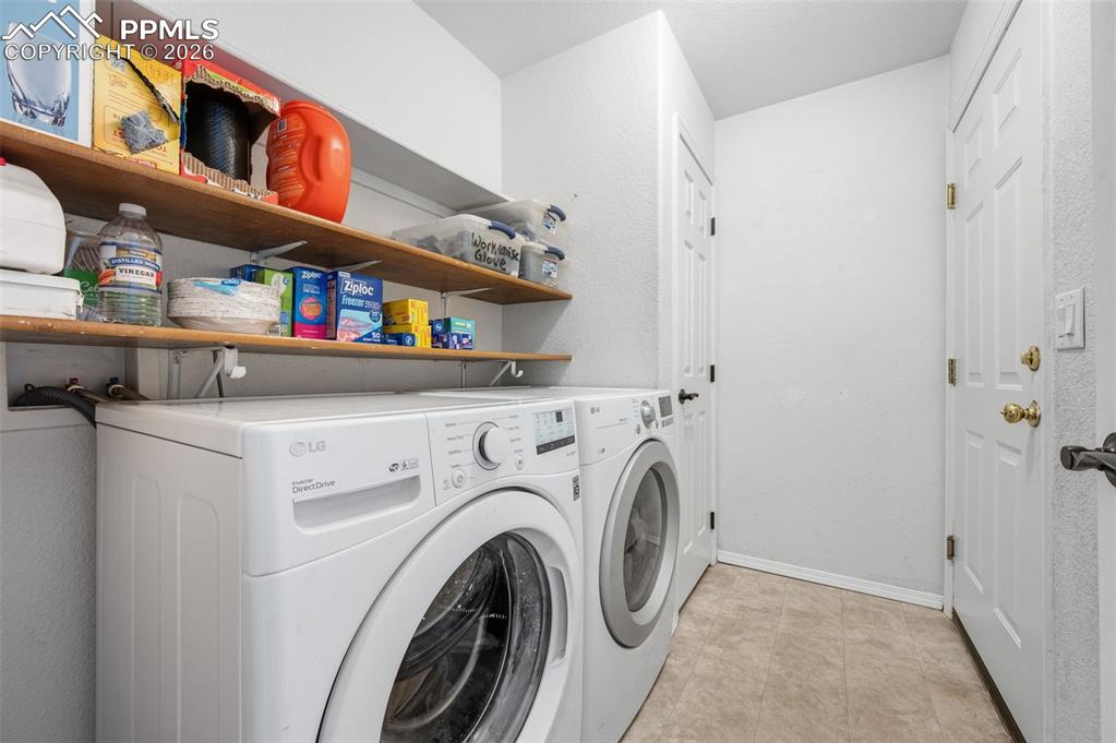 Image 24 of 36: Main level laundry room with access to garage and off the dining room