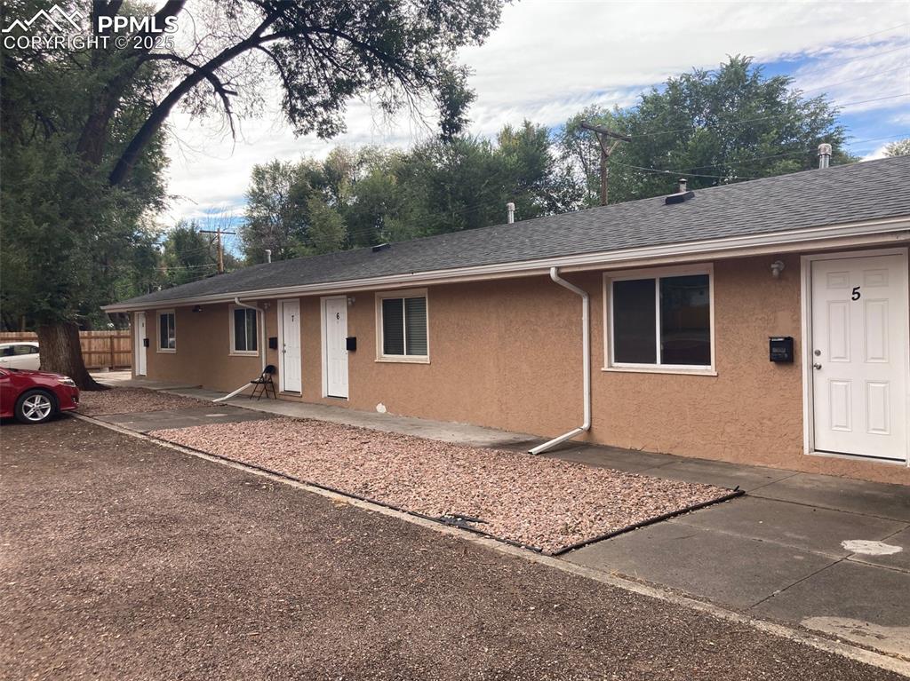 Image 10 of 26: Ranch-style house featuring stucco siding and roof with shingles