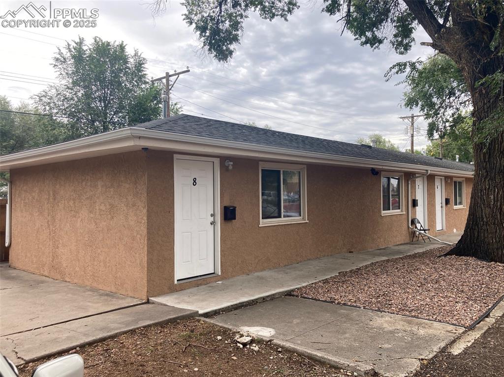 Image 11 of 26: Ranch-style home with stucco siding and roof with shingles