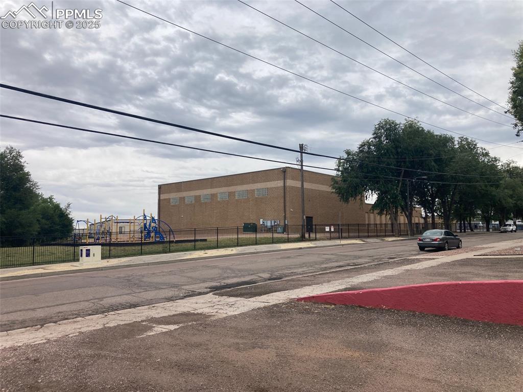 Image 18 of 26: View of asphalt road featuring sidewalks and curbs