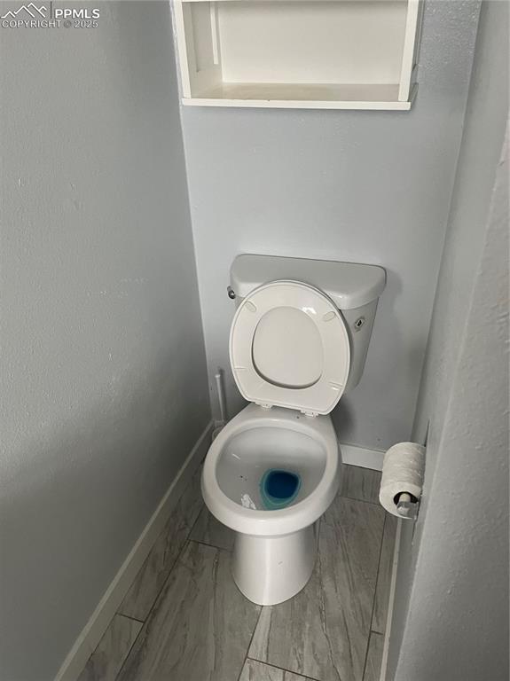 Image 24 of 26: Bathroom with baseboards and light marble finish floors