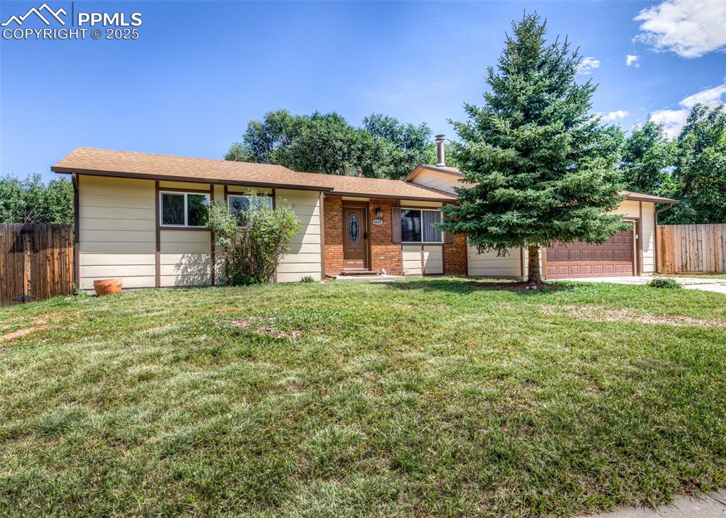 Image 2 of 48: Single story home featuring brick siding, an attached garage, and a shingle