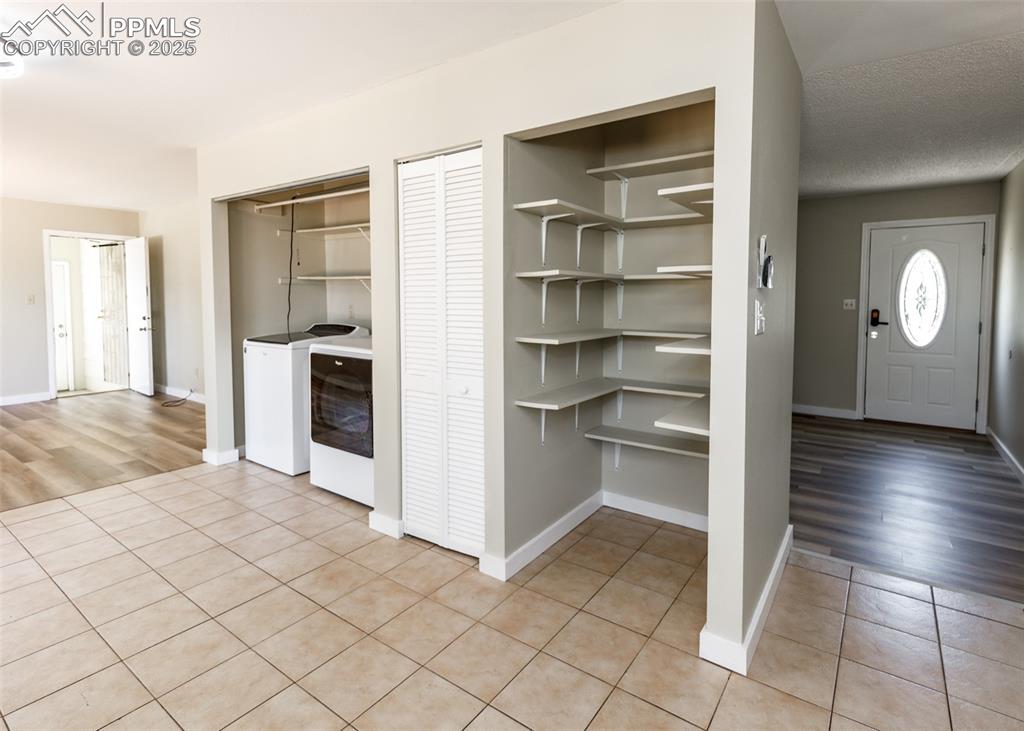 Image 20 of 48: Pantry featuring washer and dryer
