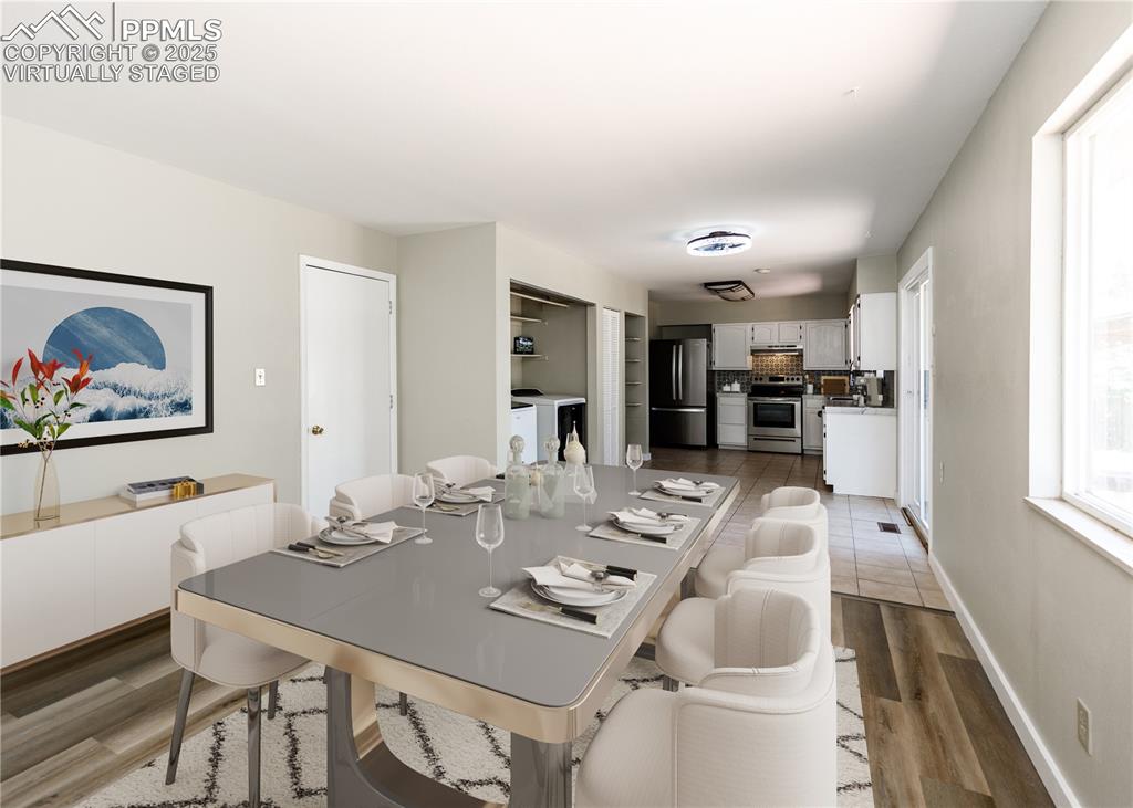 Image 23 of 48: Dining space with light wood-style floors and baseboards. virtually staged