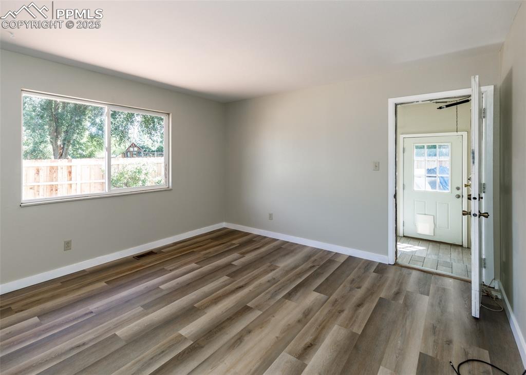 Image 26 of 48: Spare room with light wood finished floors and baseboards