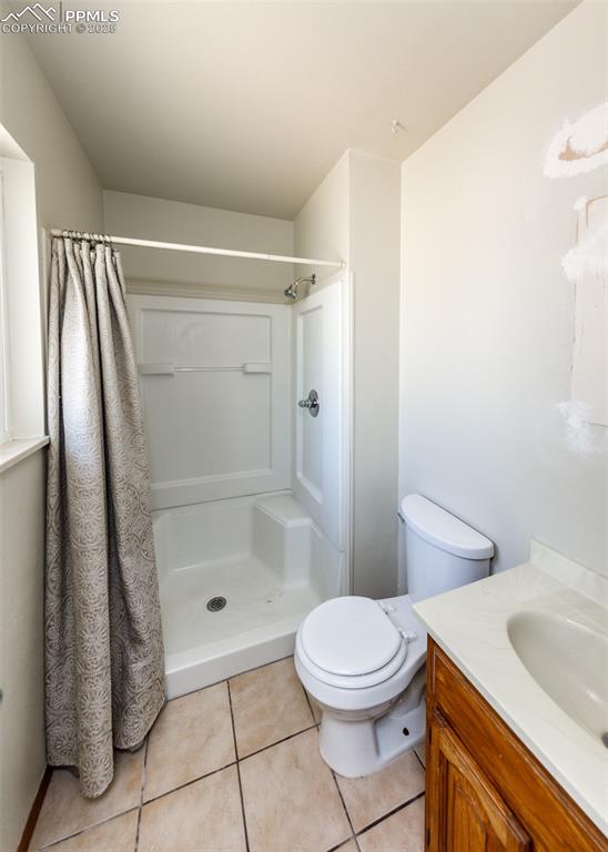 Image 35 of 48: Bathroom featuring vanity, a stall shower, and light tile patterned floorin