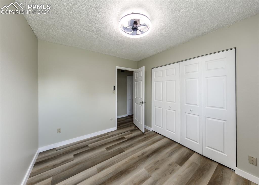 Image 39 of 48: Unfurnished bedroom featuring a textured ceiling, light wood-style flooring