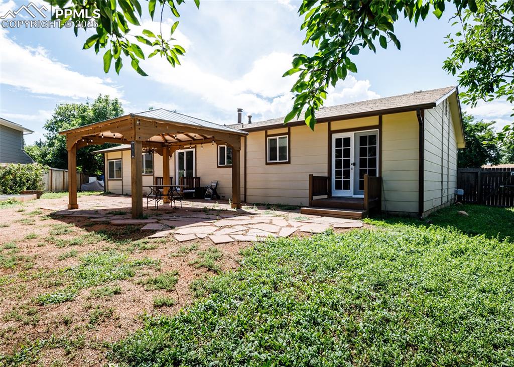 Image 46 of 48: Back of house with a fenced backyard, a patio area, and french doors