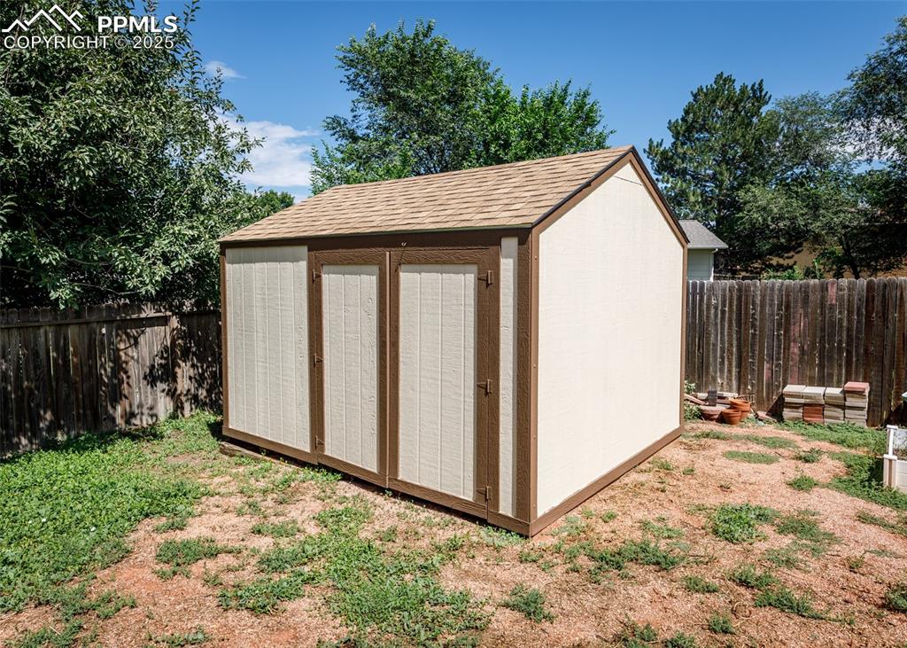 Image 48 of 48: View of shed with a fenced backyard