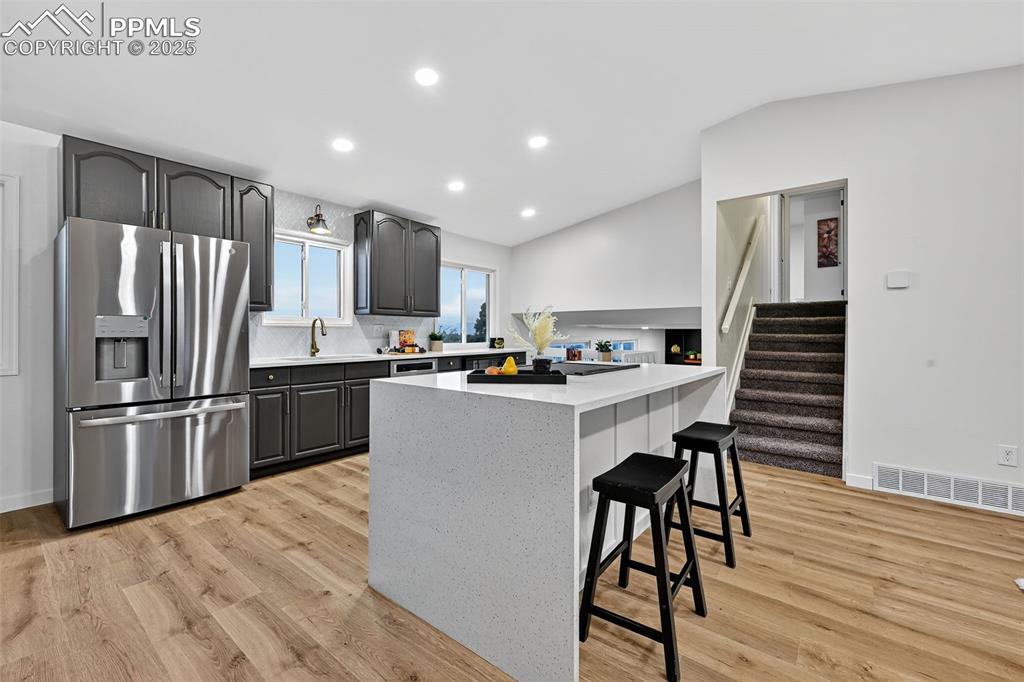 Image 11 of 48: Waterfall quartz counter tops, 40 in cabinets, stainless steel applainces