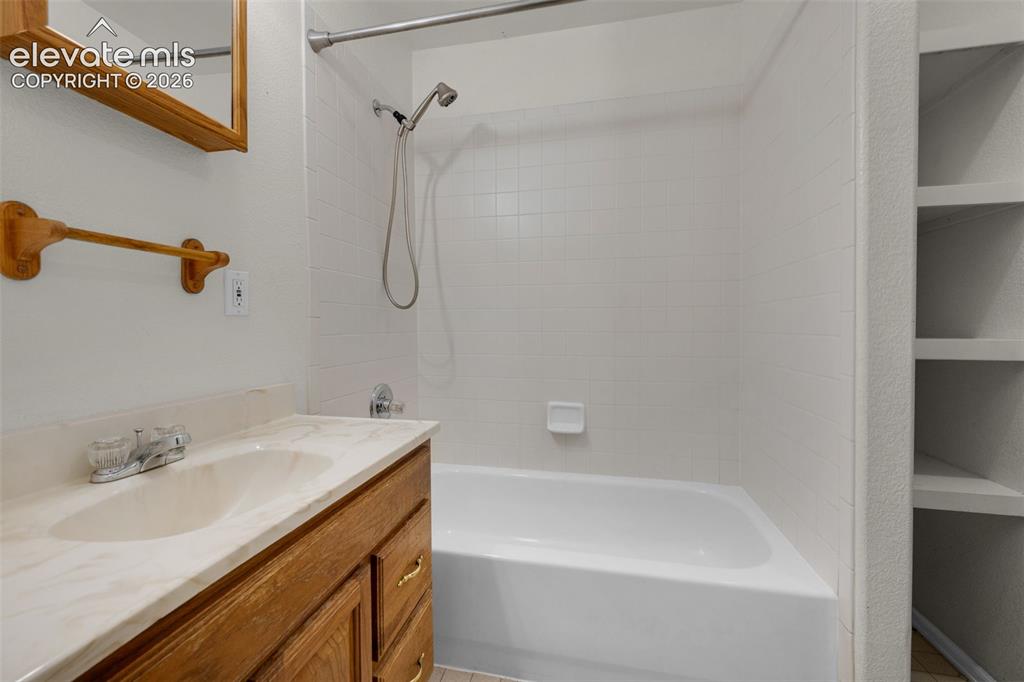 Image 26 of 29: Hall bath with laundry area