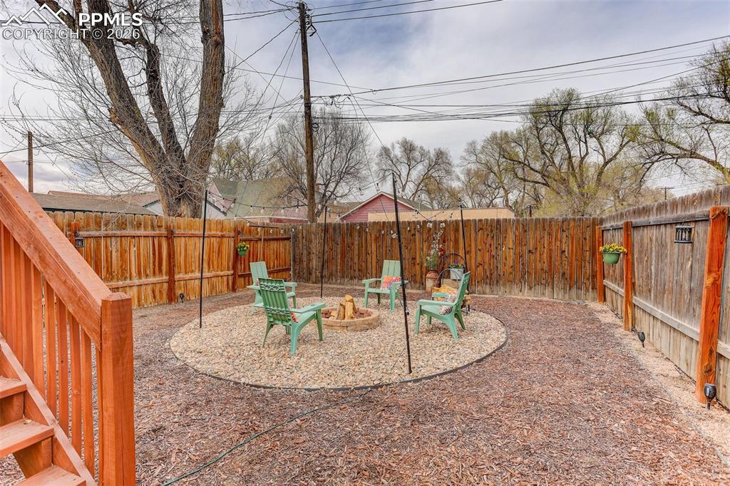 Image 21 of 41: Twinkle lights and fire pit to enjoy year round