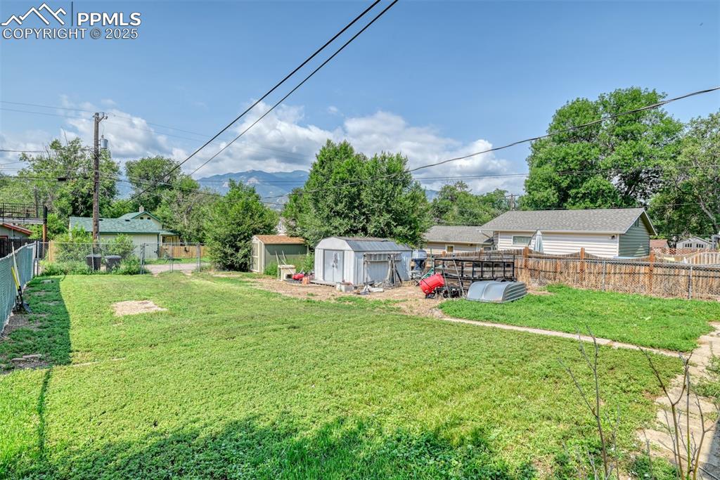 Image 7 of 38: Huge fenced backyard complete with 2 sheds, alley access and MOUNTAIN VIEWS