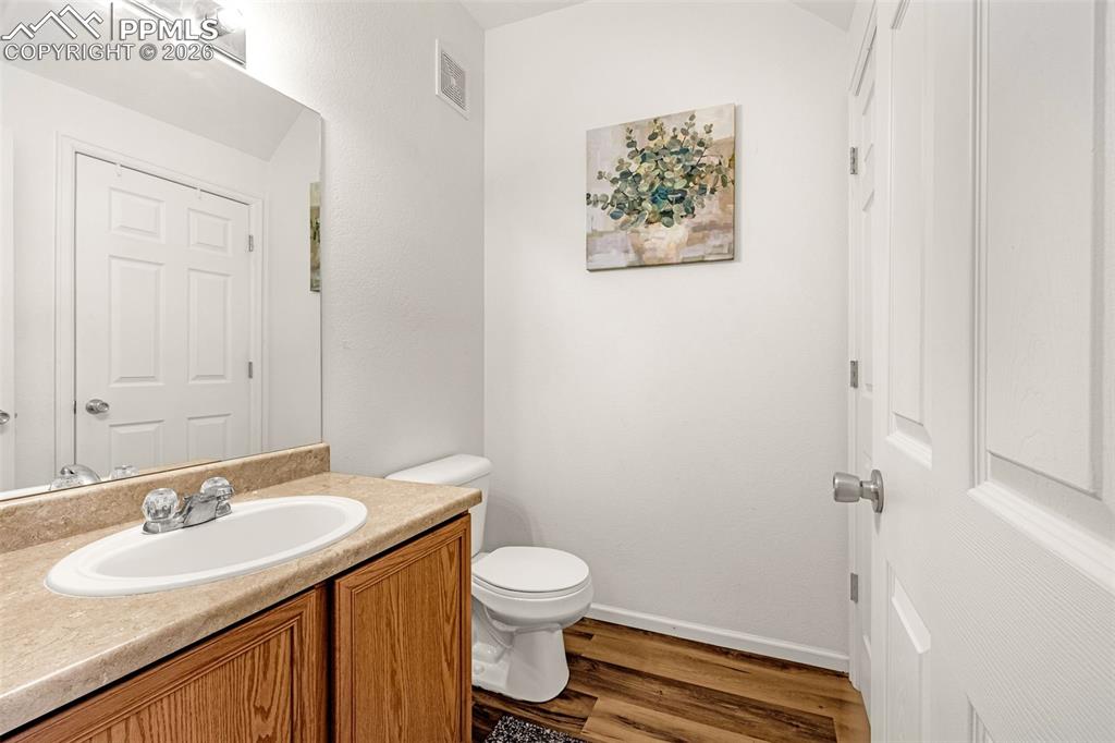 Image 10 of 29: Bathroom featuring a wood-finish vanity with an integrated sink and light-t