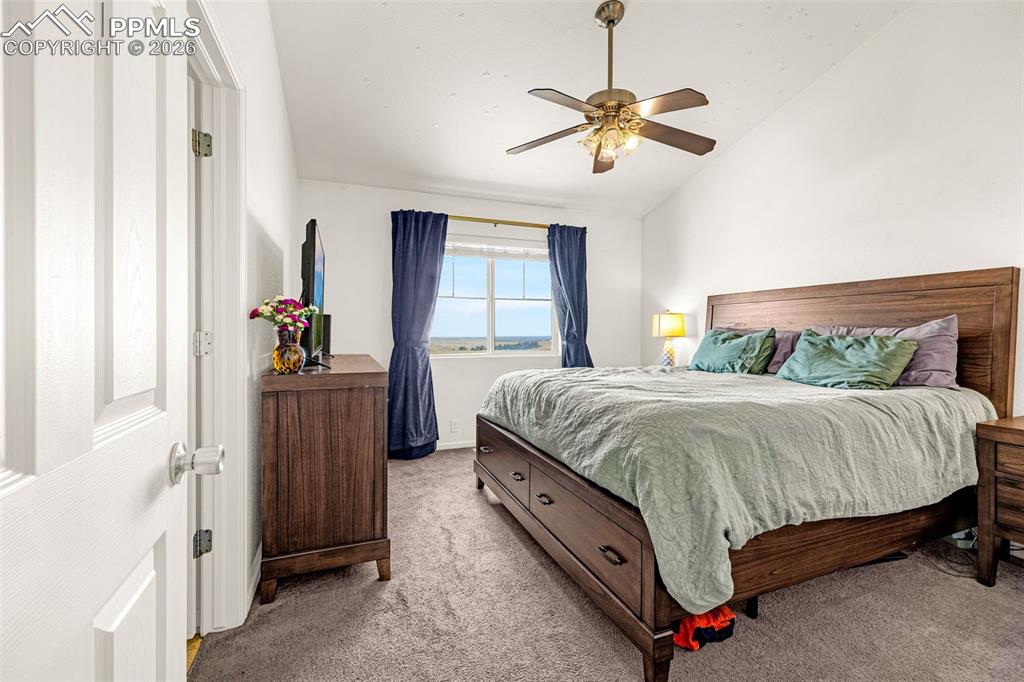 Image 14 of 29: Bedroom featuring an angled ceiling, window with outdoor scenery, ceiling f