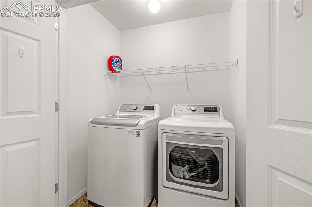 Image 20 of 29: Dedicated laundry area featuring a washer and dryer on the upper level (sam