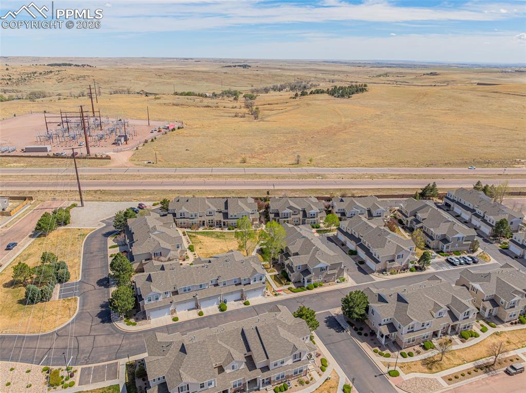 Image 23 of 29: Aerial perspective showcasing a residential community with multi-story town