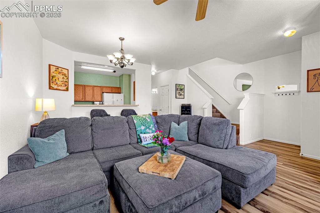 Image 5 of 29: Open-concept living area featuring wood-finish flooring and a ceiling fan