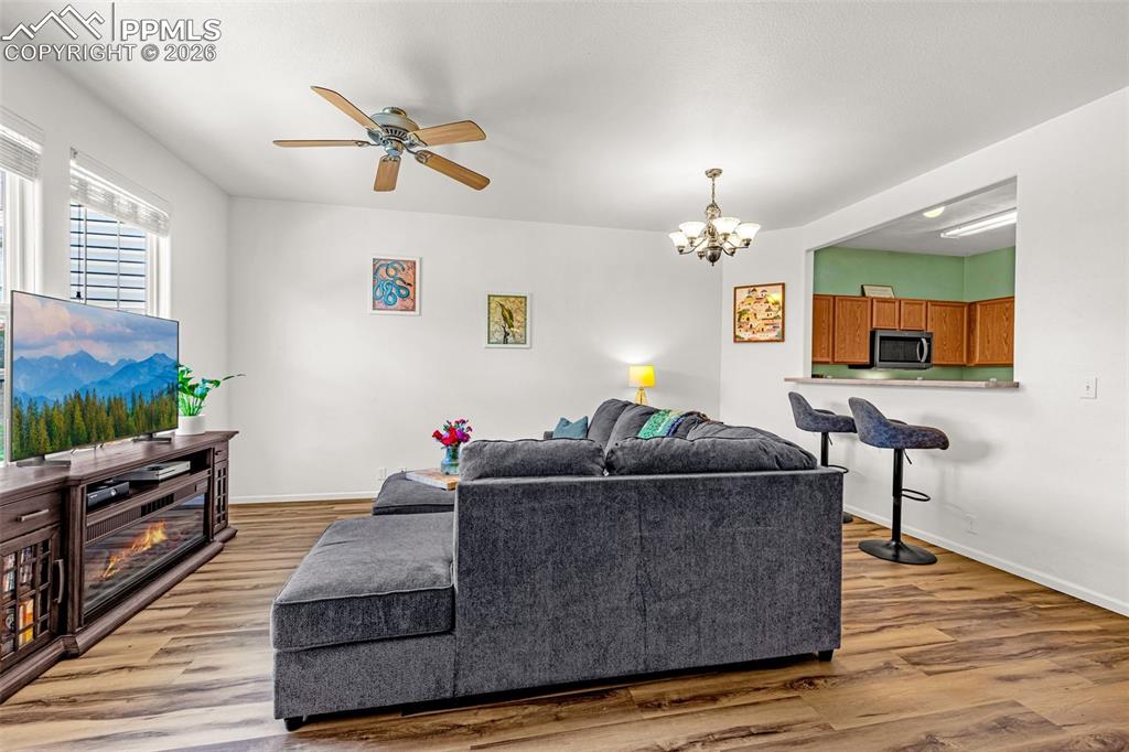 Image 6 of 29: Living area with wood-finish flooring and white walls