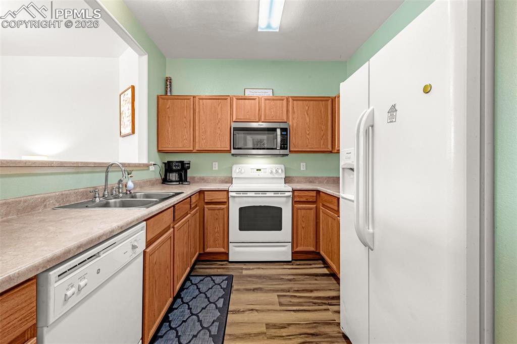 Image 8 of 29: U-shaped kitchen featuring light wood cabinetry, laminate countertops, a do