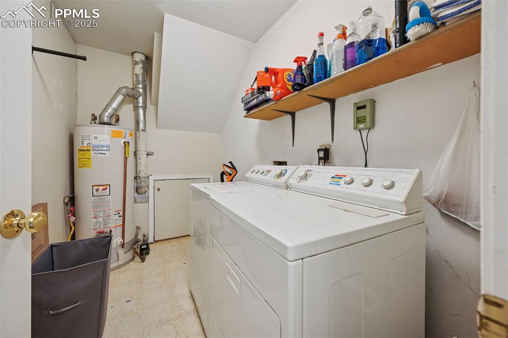 Image 21 of 27: Washroom featuring gas water heater, independent washer and dryer, and ligh