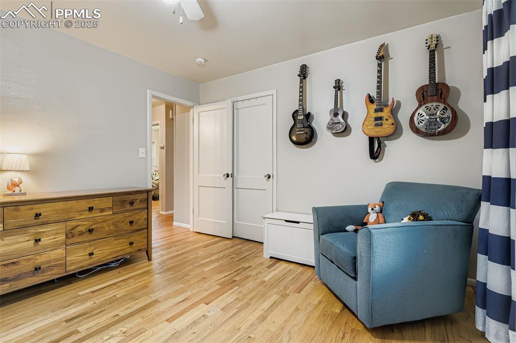 Image 12 of 22: Sitting room featuring light wood-style flooring and a ceiling fan