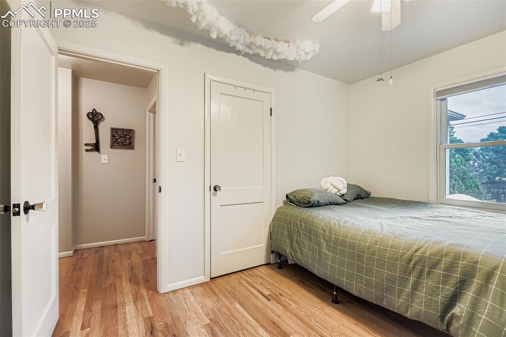 Image 14 of 22: Bedroom with light wood-type flooring and a ceiling fan