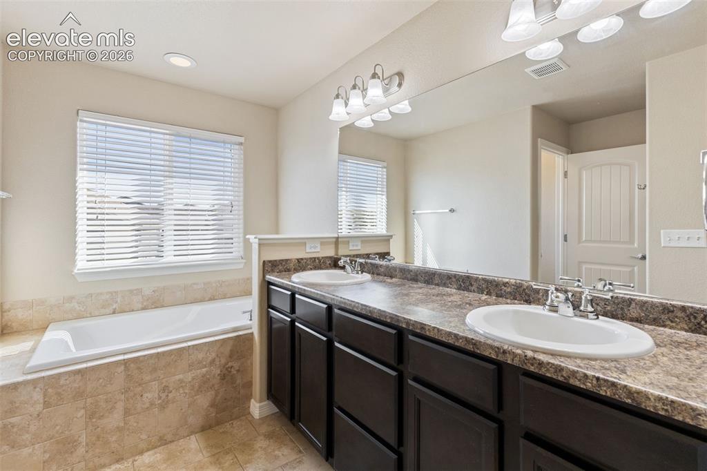 Image 18 of 46: 5-piece bathroom with walk-in closet.