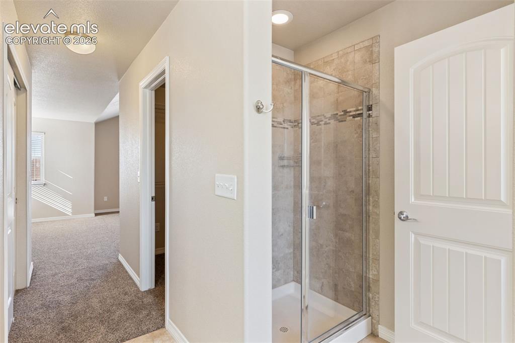 Image 19 of 46: 5-piece bathroom with walk-in closet.