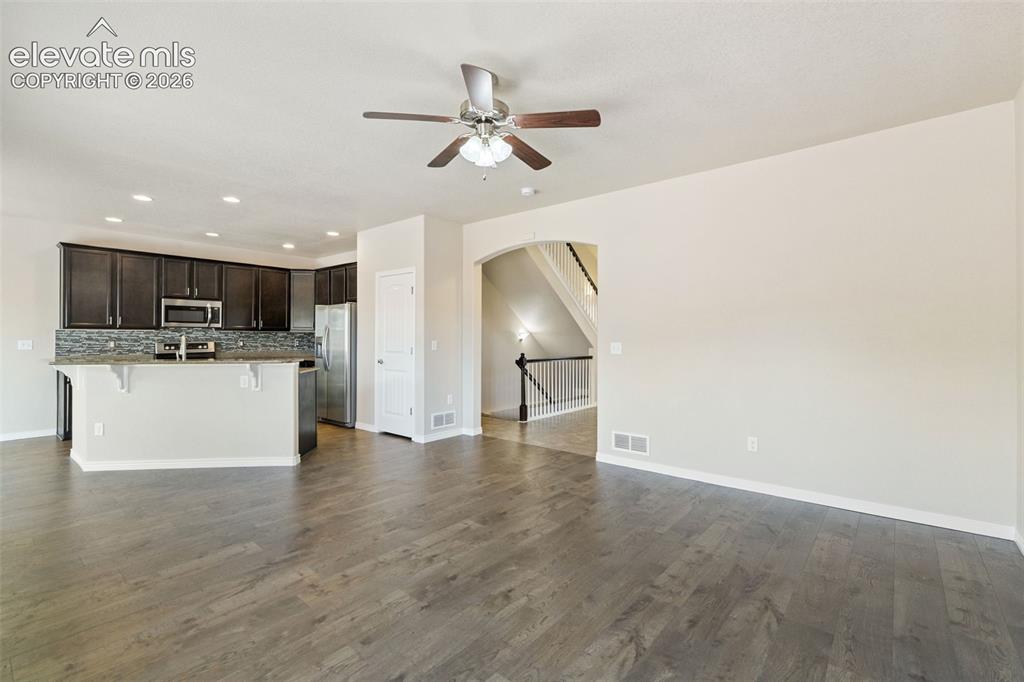 Image 5 of 46: Open concept living room, kitchen and dining area.  New luxury vinyl floori