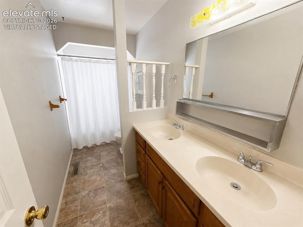 Image 20 of 27: Upstairs bathroom virtually staged to show less cluttered