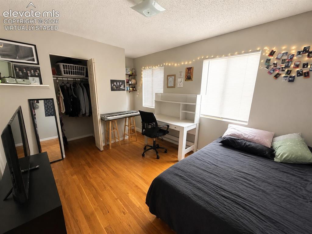 Image 22 of 27: Upstairs bedroom virtually staged to show it less cluttered