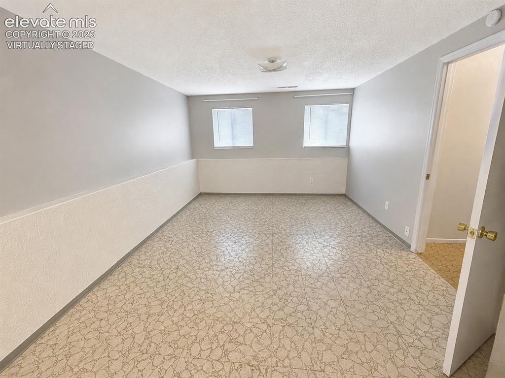 Image 8 of 27: Virtually staged to show the family room decluttered and brighter