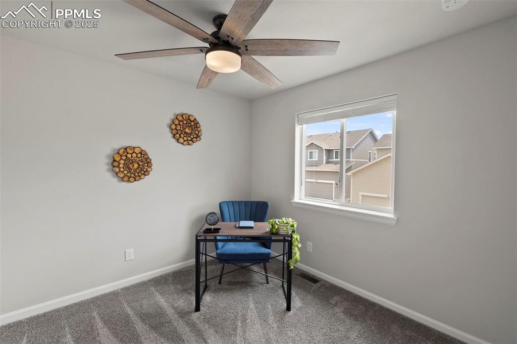 Image 16 of 24: Carpeted office space with ceiling fan and baseboards