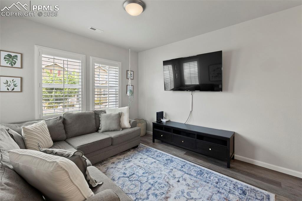 Image 3 of 24: Living room with baseboards and wood finished floors