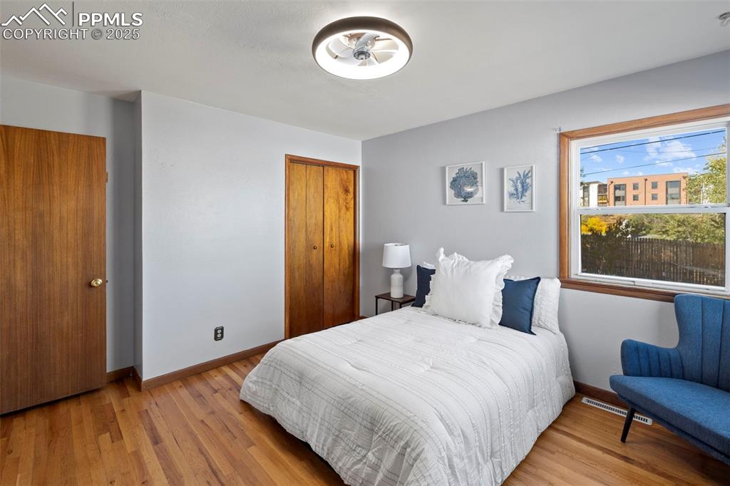 Image 11 of 30: Bedroom with light wood-type flooring and a closet