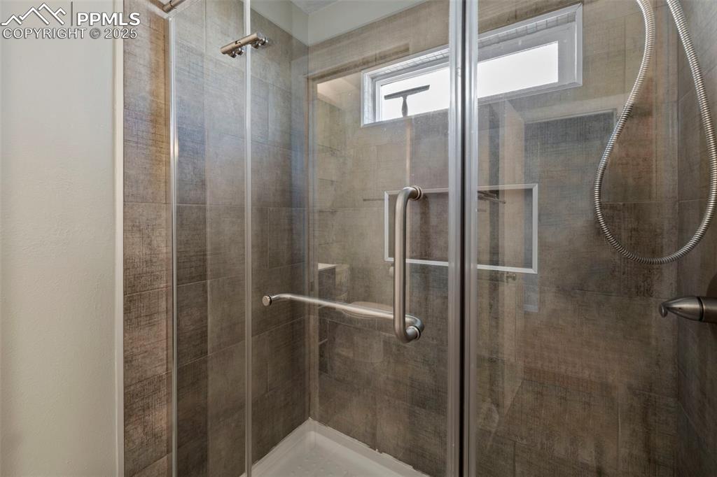 Image 14 of 30: Bathroom featuring a stall shower